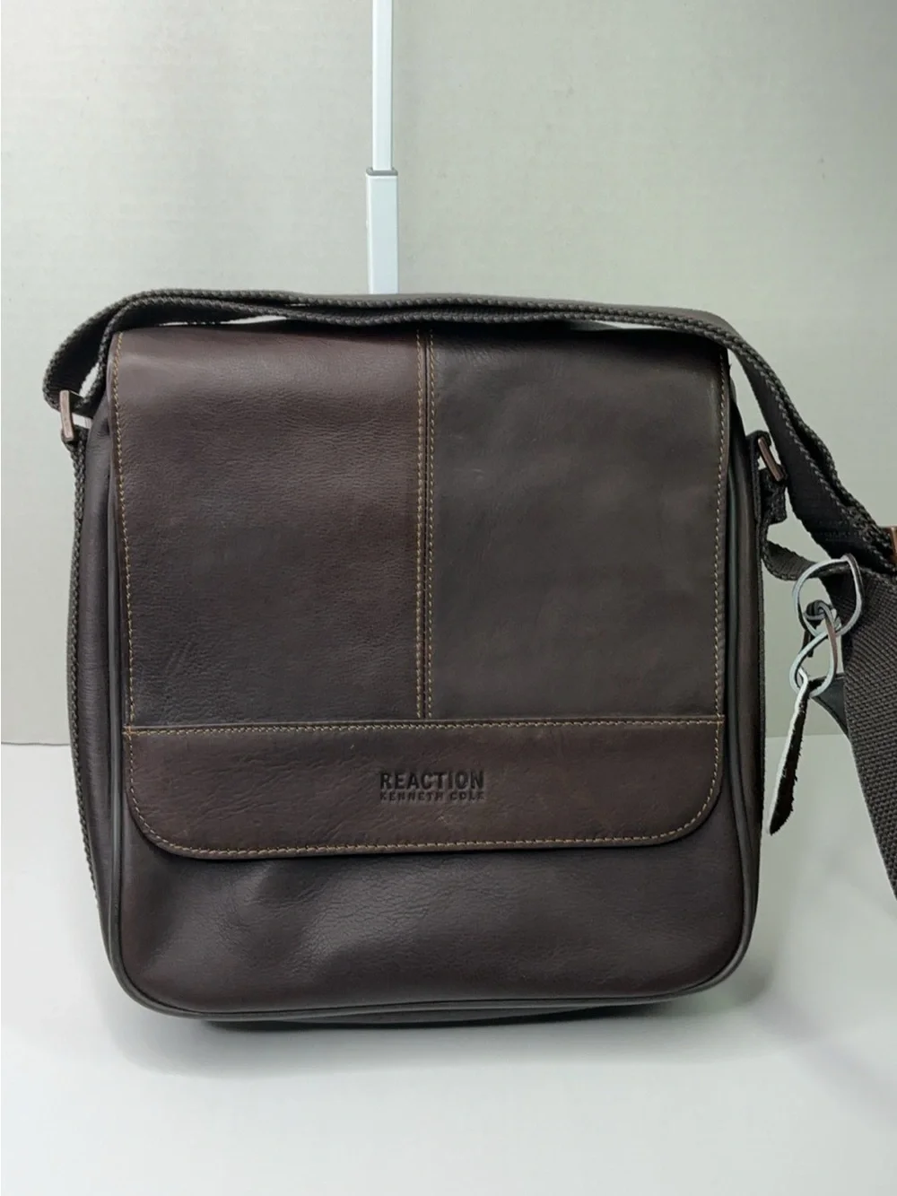 Kenneth Cole Reaction dark brown leather messenger-style tablet bag.